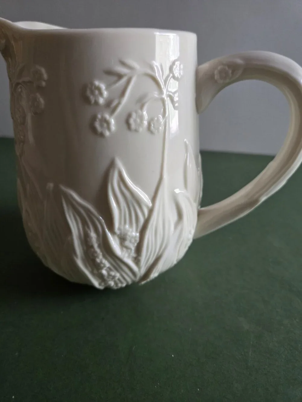Pair of Ivory Bisque Pitchers